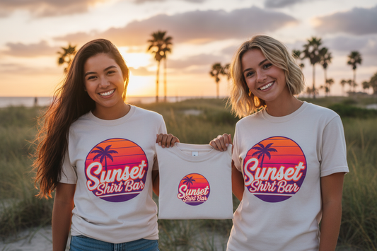 Two women wearing Sunset Shirt Bar t-shirts with vivid logo outdoors
